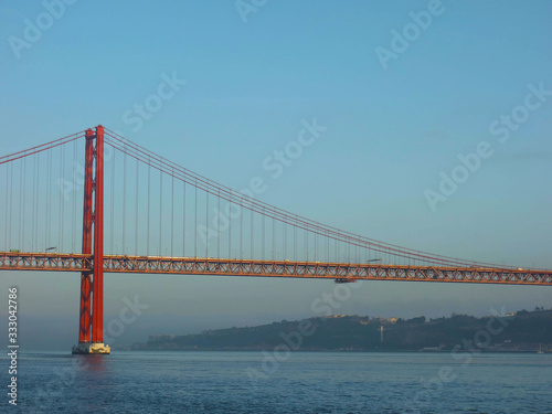 Lisbon, Portugal-23 December 219: skyline, red bridge on 25 April crossing the river Tejo on a cloudy day at dusk.