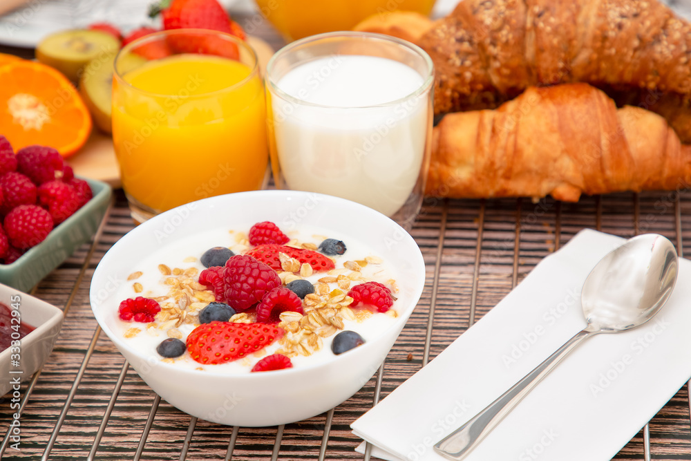 Breakfast Served in the morning with Fruit Yogurt, Butter croissant and corn flakes Whole grains and raisins with milk in cups and Strawberry, Raspberry, Kiwi, Fresh Orange Juice on breakfast table Breakfast Served in the morning with Fruit Yogurt, Butter croissant and corn flakes Whole grains and raisins with milk in cups and Strawberry, Raspberry, Kiwi, Fresh Orange Juice on breakfast table
