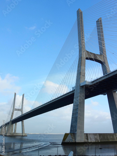 Fototapeta Naklejka Na Ścianę i Meble -  The Vasco de Gama Bridge Lisbon crosses the river Tejo on a cloudy day.