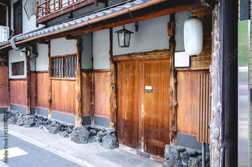 Japanese paper lamp and traditional wood frontis of home in Kyoto, Japan photo