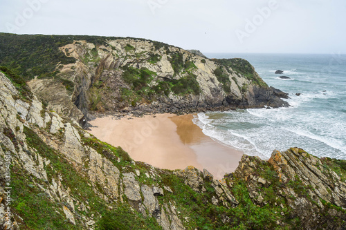 Adegas beach, in Aljezur, Portugal. Naturism beach surrounded by cliffs photo