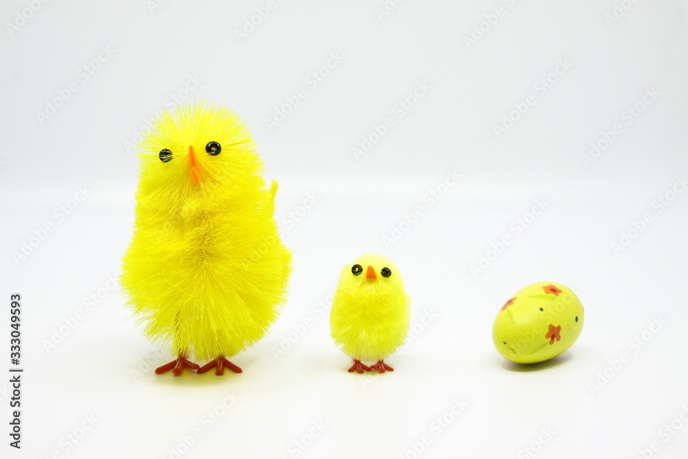Cute little Easter chicks standing in a row with an Easter egg