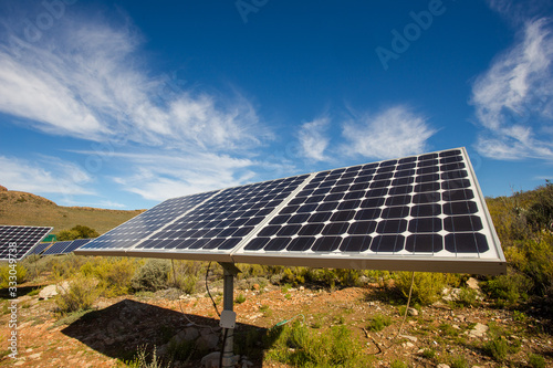 Close up wide angle view of photovoltaic solar panels on an off the grid electricity instalation on a farm in the Karoo outside Touwsrivier in the western cape of south africa