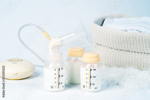 Medical electric breast pump to increase milk supply for breastfeeding mother and children's clothing photo