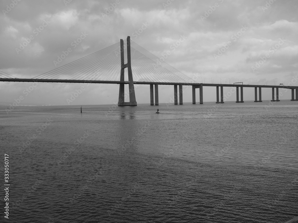 Vasco de Gama Bridge Lisbon crossing the river Tejo on a cloudy day.