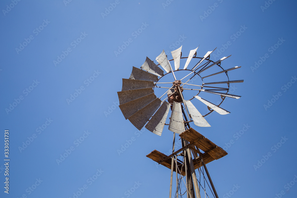 Wide amgle view of a lone windpomp / windmill on the plains of t