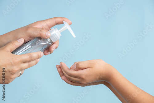 Fotografía Woman applying an antibacterial antiseptic gel for hands disinfection and health protection during flu virus outbreak