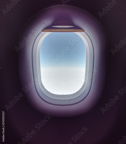 Blue stratosphere behind plane window. Beautiful background of airplane window