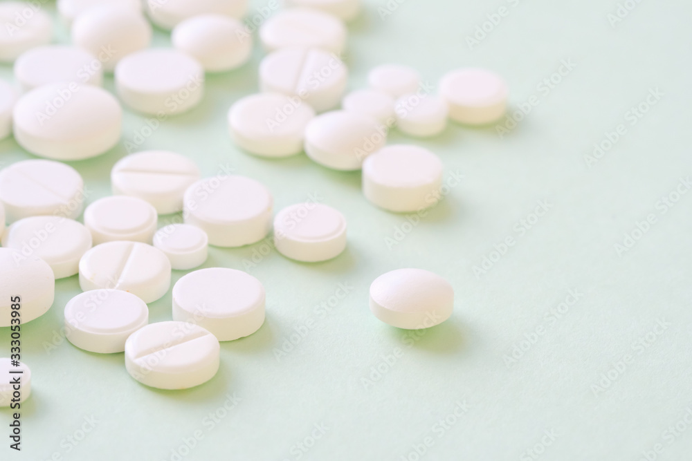 Pharmaceutical medicine pills, tablets and capsules over green Pharmaceutical medicine pills, tablets and capsules over green