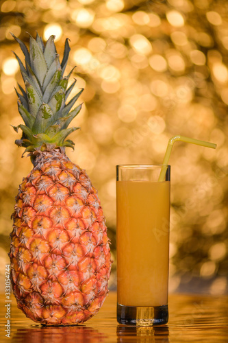 pineapple with juice on gold background