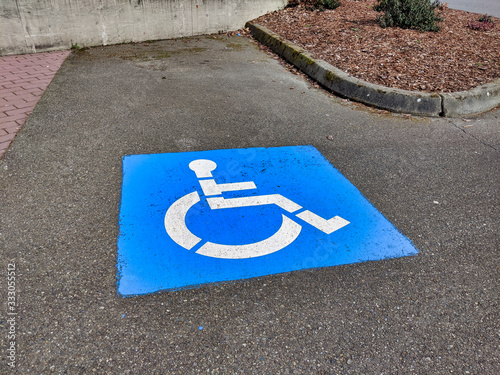blue handicapped parking paint marker in a parking lot outdoors