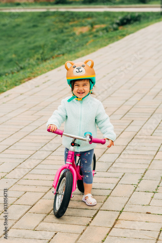 Fototapeta Naklejka Na Ścianę i Meble -  Toddler Girl Riding Bike
