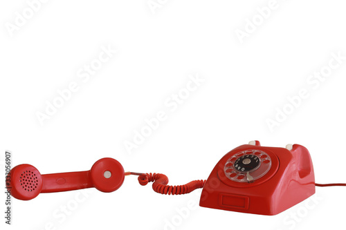 Vintage red telephone with off-hook handset white background
