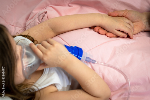 sick little girl is using a medical ventilator