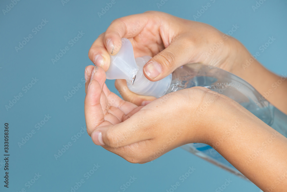 Woman applying an antibacterial antiseptic gel for hands disinfection and health protection during flu virus outbreak. Coronavirus quarantine and covid-19 Woman applying an antibacterial antiseptic gel for hands disinfection and health protection during flu virus outbreak. Coronavirus quarantine and covid-19