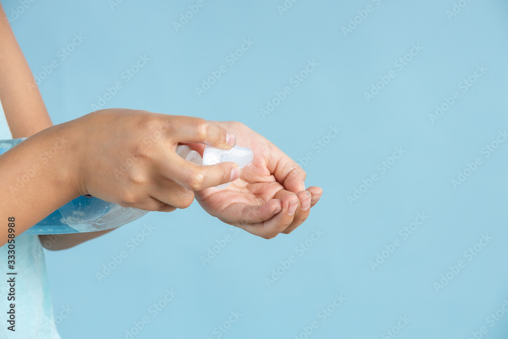 Woman applying an antibacterial antiseptic gel for hands disinfection and health protection during flu virus outbreak. Coronavirus quarantine and covid-19 Woman applying an antibacterial antiseptic gel for hands disinfection and health protection during flu virus outbreak. Coronavirus quarantine and covid-19