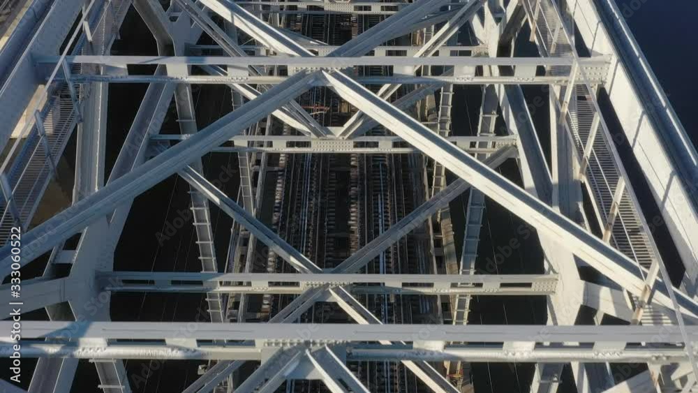Darnitsky bridge over the Dnieper River. Ukraine city Kiev. Warm winter. Dawn. Video from the drone. Span over the construction of the railway bridge towards the city Darnitsky bridge over the Dnieper River. Ukraine city Kiev. Warm winter. Dawn. Video from the drone. Span over the construction of the railway bridge towards the city