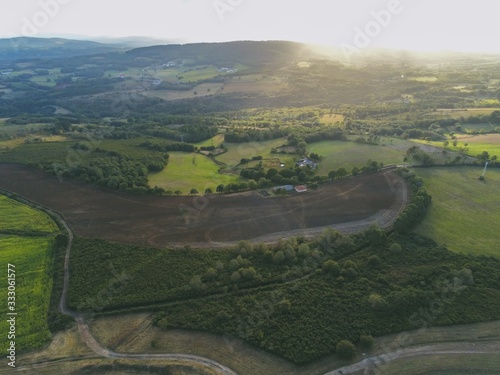 Aerial shot of fields covered in trees at Camino de Santiago in Galicia, Spain photo