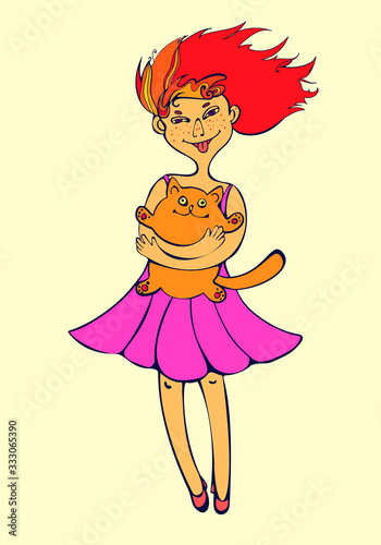 red-headed cheerful mischievous girl shows tongue and holds a cat photo