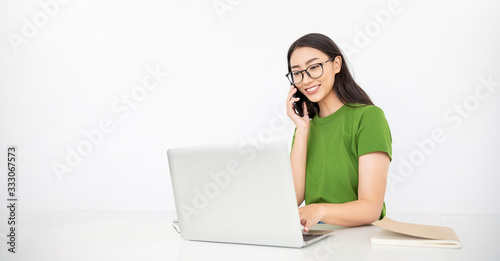Portrait of young asian business woman talk on smartphone write notebook laptop in home office. Beautiful girl at desk computer take order. Startup business asia woman online telemarketing sme owner