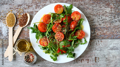 Selective focus. Healthy fresh arugula cherry salad on a plate. Vegan diet. Healthy food.