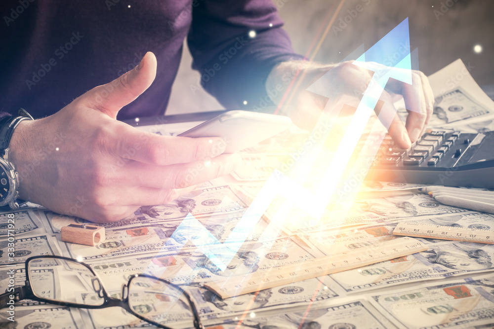 Double exposure of man's hands holding and using a digital device and arrows hologram drawing. Success concept. Double exposure of man's hands holding and using a digital device and arrows hologram drawing. Success concept.