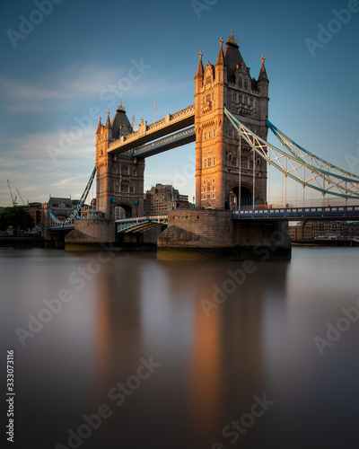 Tower Bridge located in London city  United Kingdom with beautiful blue sky background. Calm River Thames in long exposure shot with tourism  tourist view in city landscape
