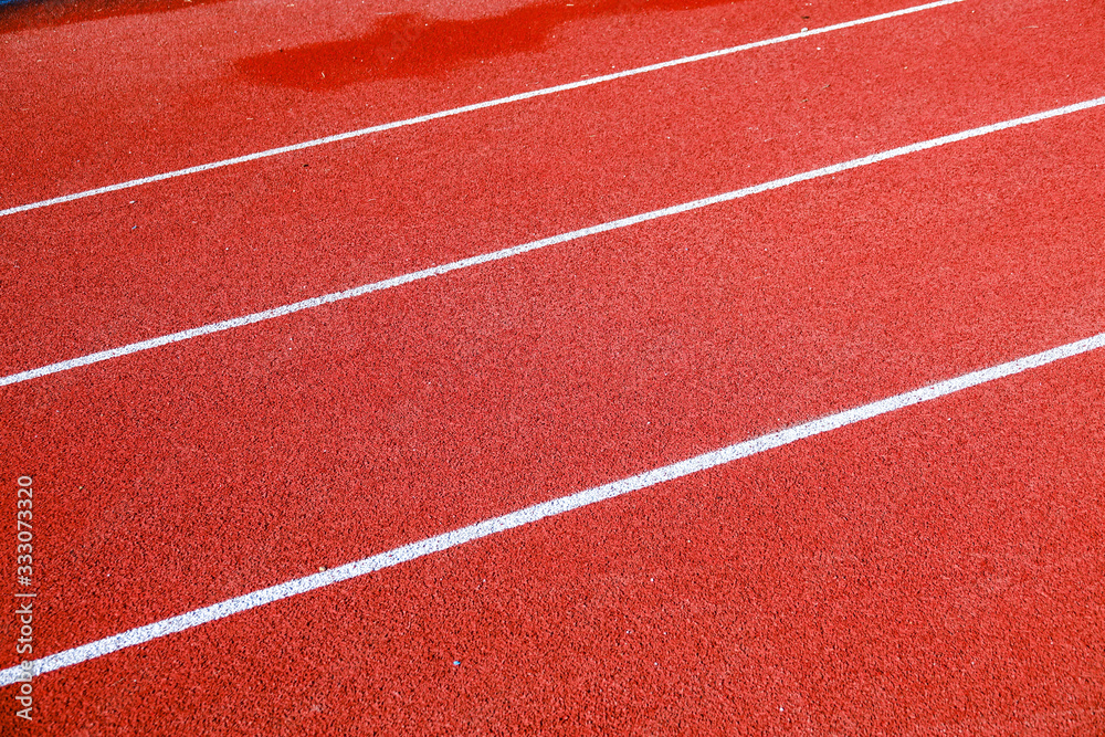 Athletic running track for running race. Sport and excercise concept. Athletic running track for running race. Sport and excercise concept.