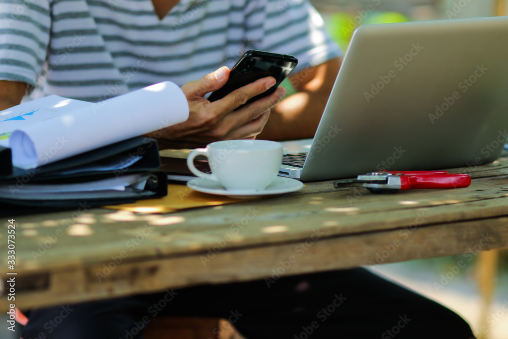 Young asian man working online from home at the garden. Man using laptop for online working at home. Young asian man working online from home at the garden. Man using laptop for online working at home.