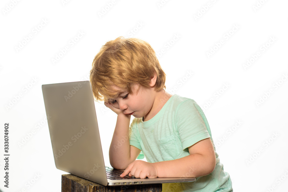 Distance Learning. Boy with notebook. Online homework. Modern technology. Little boy with laptop at home. Internet, homework and social media. Cute kid playing computer at home. Learning concept. Distance Learning. Boy with notebook. Online homework. Modern technology. Little boy with laptop at home. Internet, homework and social media. Cute kid playing computer at home. Learning concept.