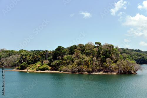 Green landscape of Panama Canal, view from the transiting cargo ship.