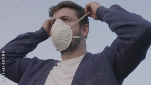 Young Man Putting Protective Mask for Prevention Against Coronavirus Pandemic 2