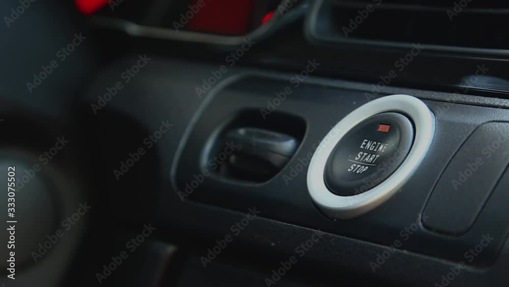 Starting car engine. Finger press the button to start the car engine Starting car engine. Finger press the button to start the car engine