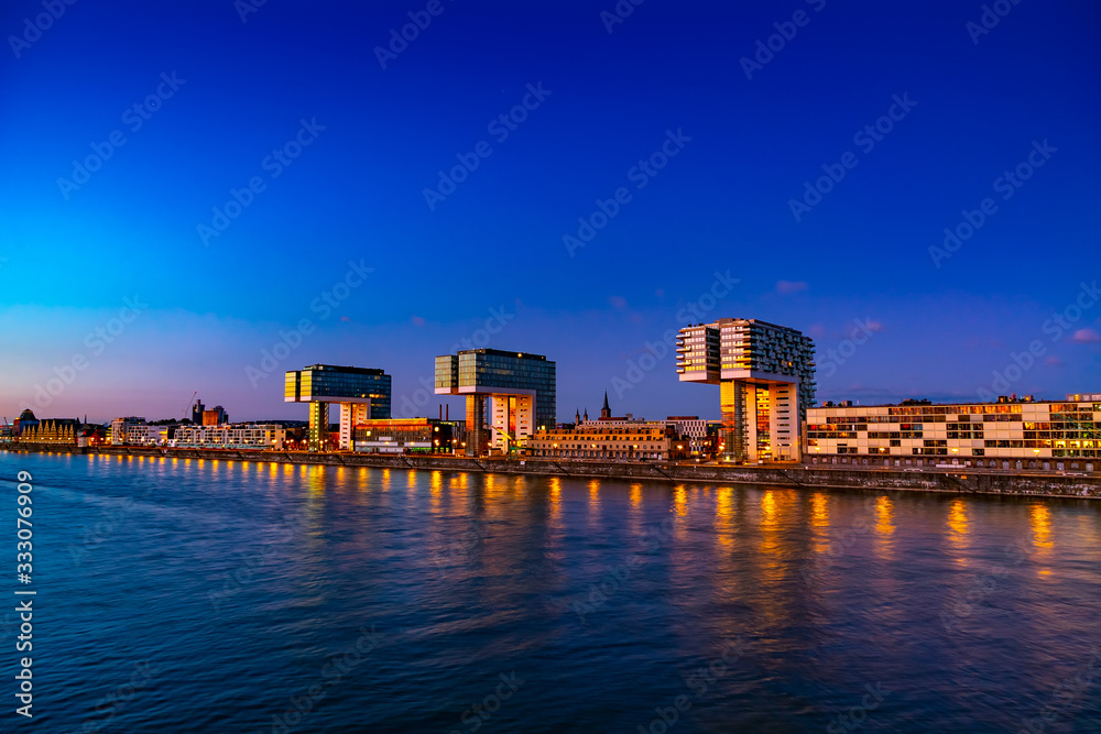 Panorama of night view of Cologne in Germany, beautiful cityscape by the Rhine at sunset 