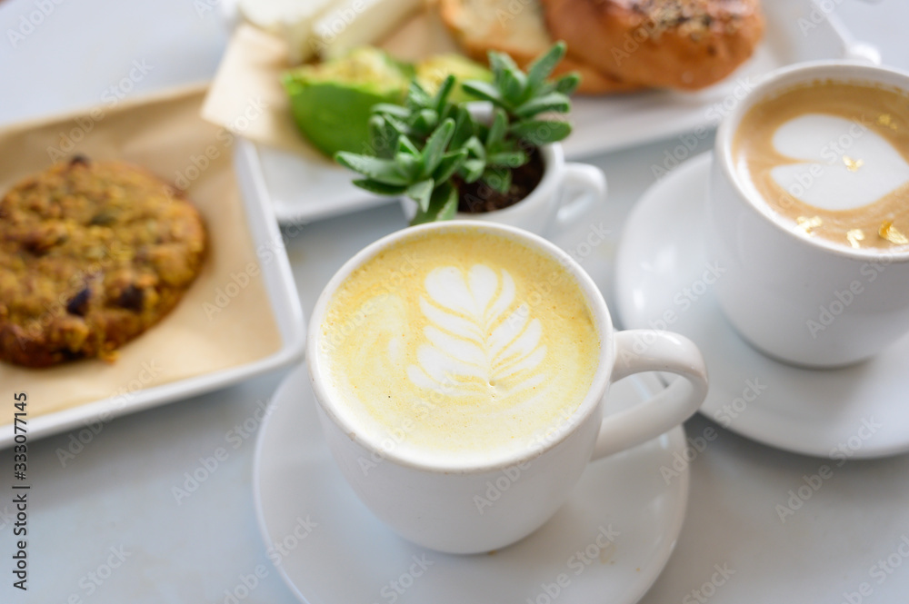 Cafe Latte table set with breakfast and green plant Cafe Latte table set with breakfast and green plant