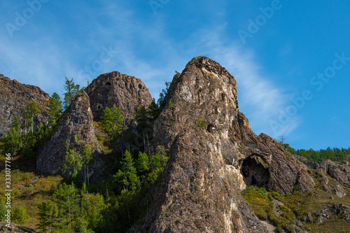 small cave or grotto in mountain cliff, mountaineering and caving in rocks