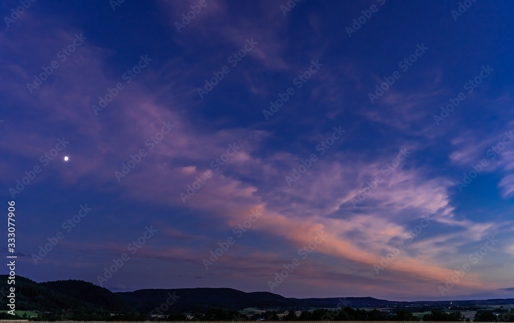 Beautiful sunset against the evening sky; colorful cloulds in the sky