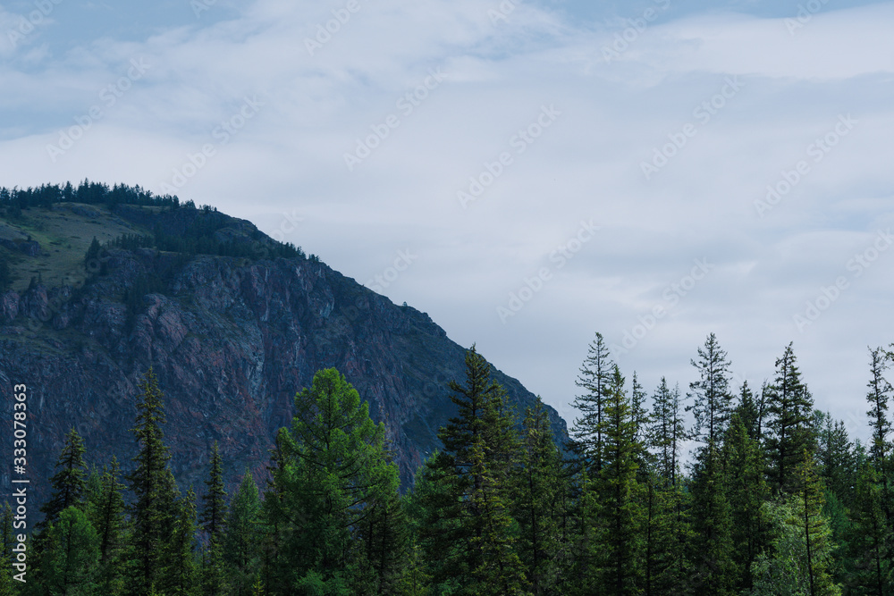 silhouette of mountain range on horizon, rocks and cliffs in mountain valley, tourist trip to mountains