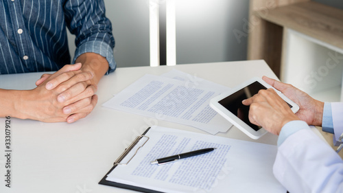 Technology in medicine and health care, Doctor consultation Discussing Records with the patient by using digital tablet in doctors office