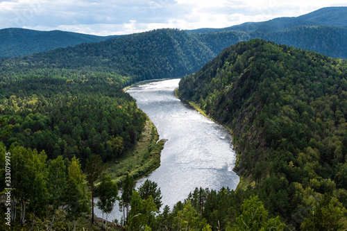 wide river between green hills  smooth bend of riverbed  contemplation of nature for meditation and relaxation