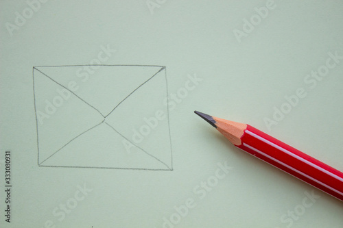 An envelope drawn in pencil on a paper sheet, Close-up.