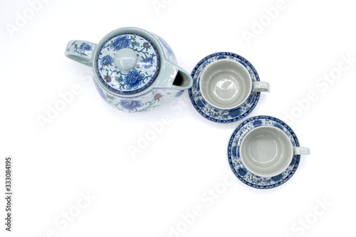 cup with tea and teapot on white  background, over light