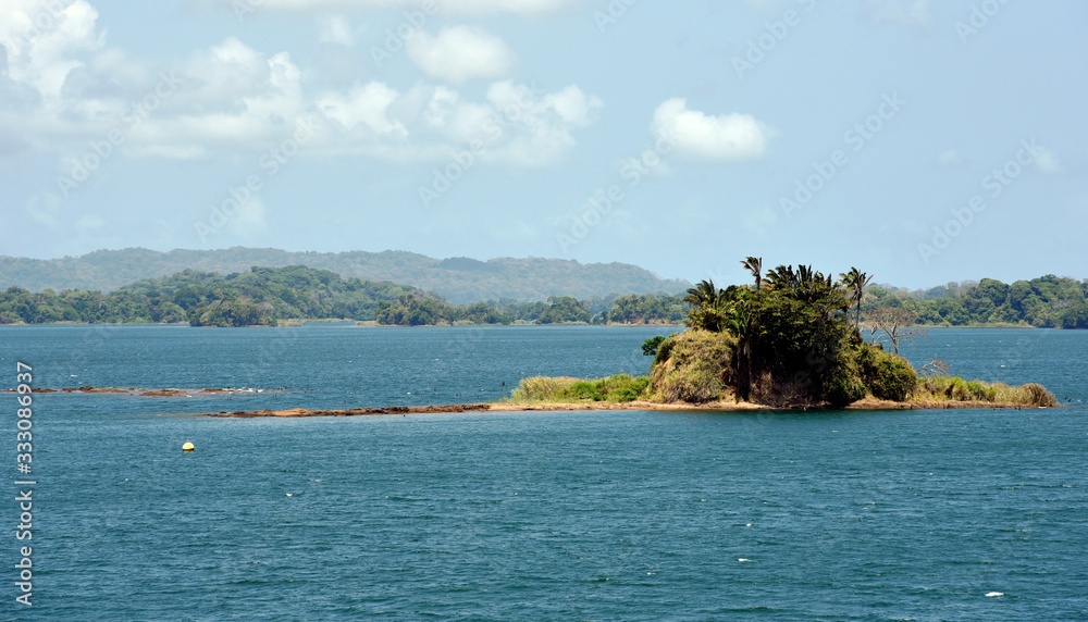 Green landscape of Panama Canal, view from the transiting cargo ship. Green landscape of Panama Canal, view from the transiting cargo ship.