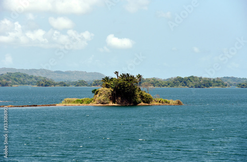 Green landscape of Panama Canal, view from the transiting cargo ship.