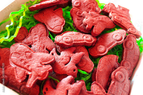 Christmas holiday sugar shortbread cookies. Bright colored figures of cakes made of space sand, dough, plasticine in the form of a car, plane, train close-up. Food as background and texture