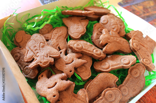 Christmas holiday sugar shortbread cookies. Bright colored figures of cakes made of space sand, dough, plasticine in the form of a car, plane, train close-up. Food as background and texture