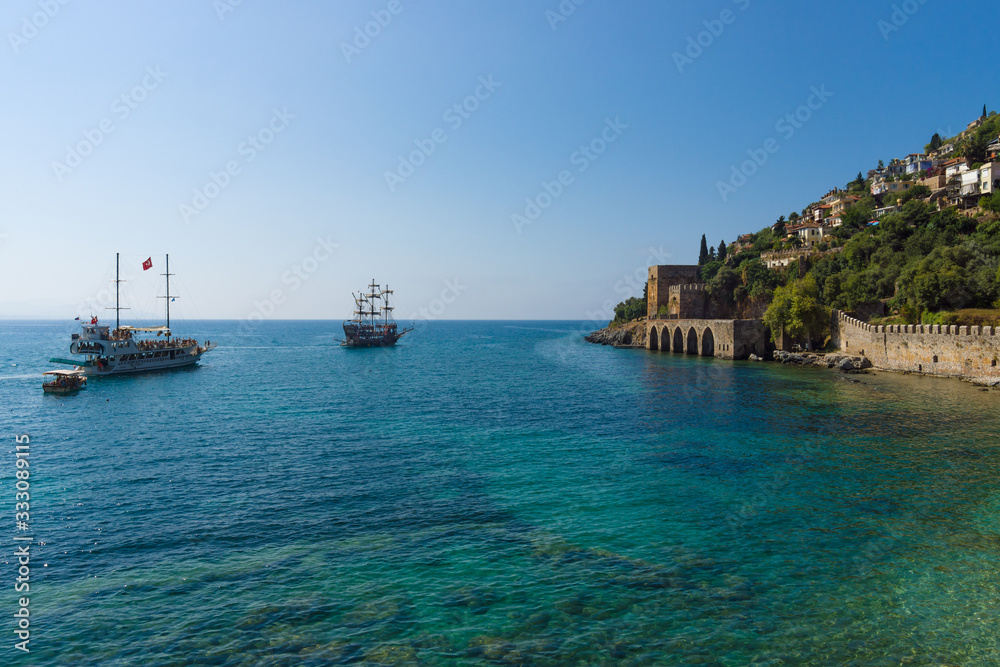 Alanya. Turkey. Shipyard (Tersane) and the ruins of a medieval fortress (Alanya Castle) on the mountainside.