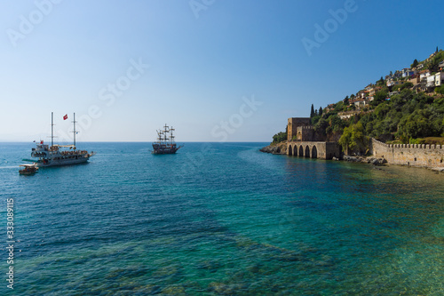 Fototapeta Naklejka Na Ścianę i Meble -  Alanya. Turkey. Shipyard (Tersane) and the ruins of a medieval fortress (Alanya Castle) on the mountainside.