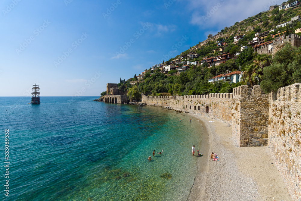 Alanya. Turkey. Shipyard (Tersane) and the ruins of a medieval fortress (Alanya Castle) on the mountainside.