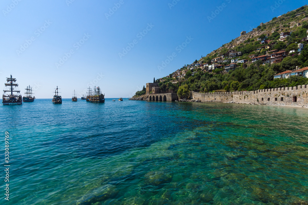 Alanya. Turkey. Shipyard (Tersane) and the ruins of a medieval fortress (Alanya Castle) on the mountainside.